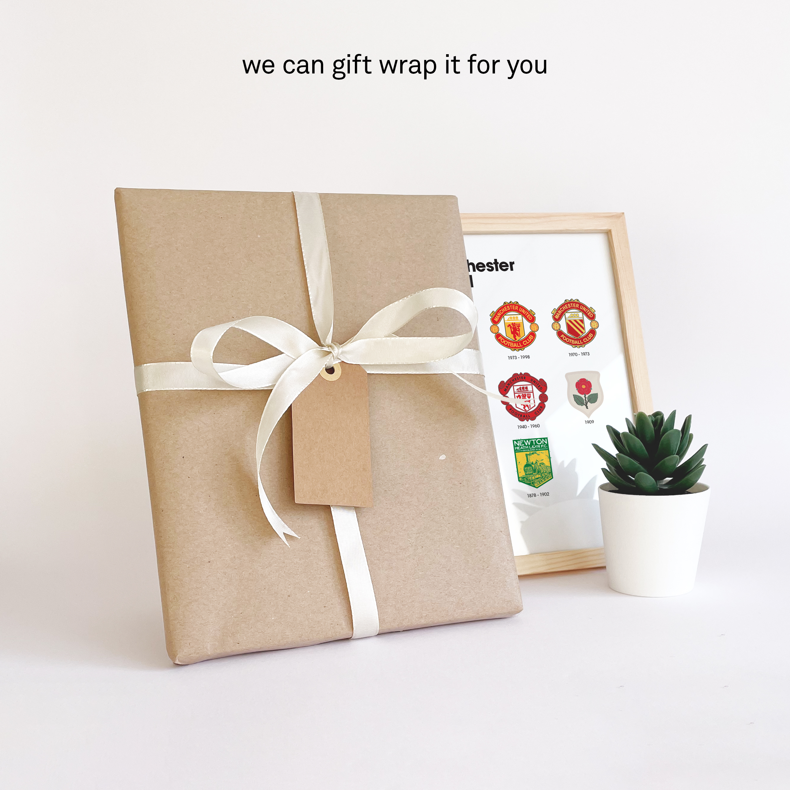 Manchester United Logo History print giftwrapped in brown durable paper with a white ribbon and a personal note card so you can send it directly to that special person